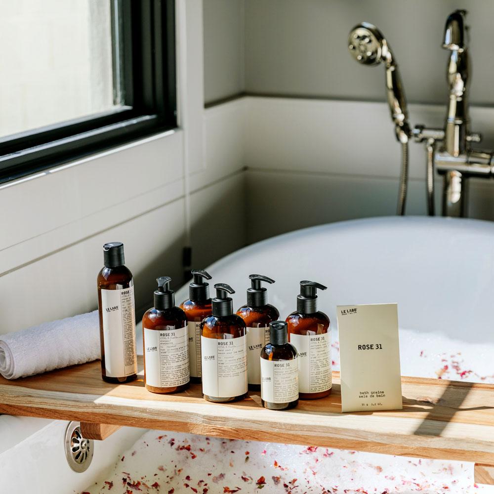 Le Labo Rose 31 collection on tray in bath tub
